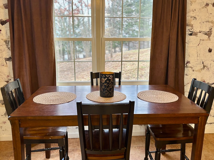 Dining room with seating for 4. Open floor plan with kitchen and living room.