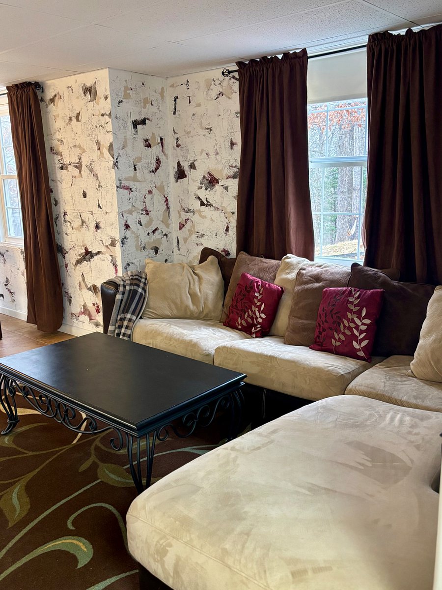 Living room with comfortable L-shaped coach and 55 inch smart TV