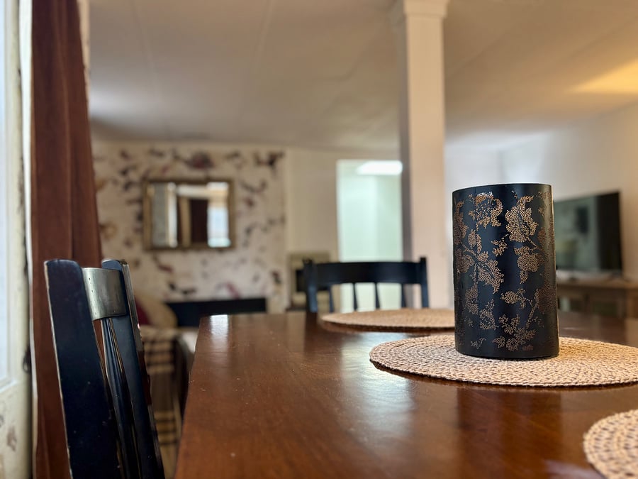 Dining room with seating for 4. Open floor plan with kitchen and living room.