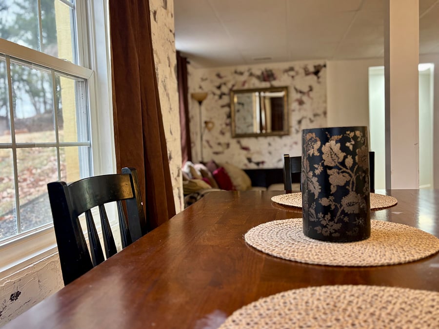 Dining room with seating for 4. Open floor plan with kitchen and living room.