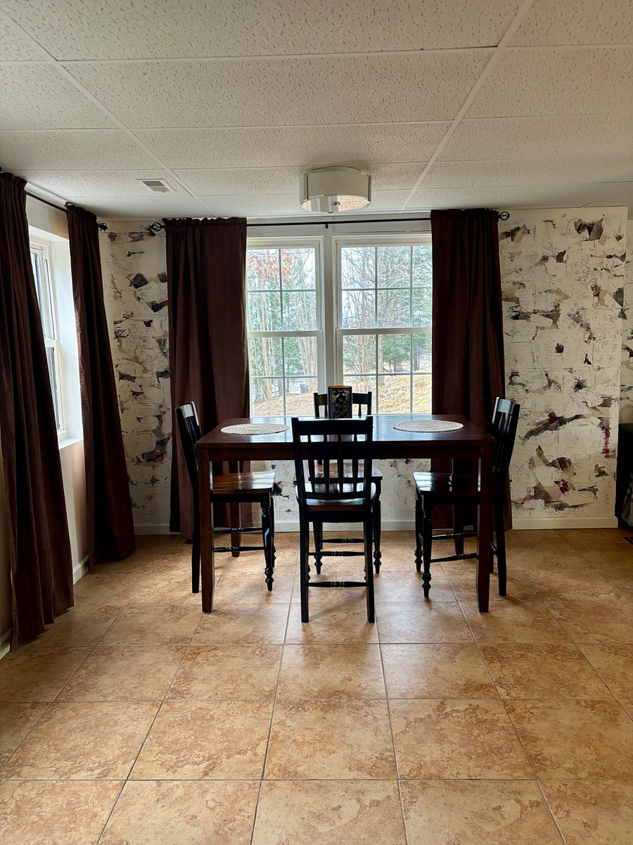 Dining room with seating for 4. Open floor plan with kitchen and living room.