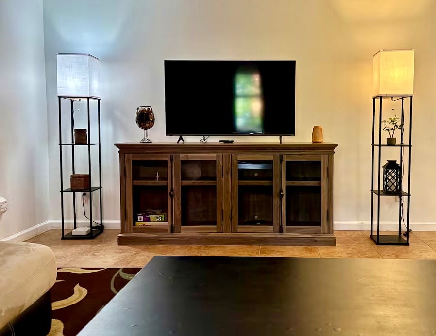 Living room with comfortable L-shaped coach and 55 inch smart TV