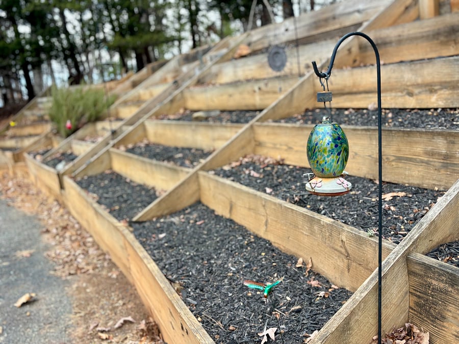 Garden located on bank directly beside private parking in front of the main entrance. Tenants are welcome to plant as desired. Gardening tools are located to the right of the front door.