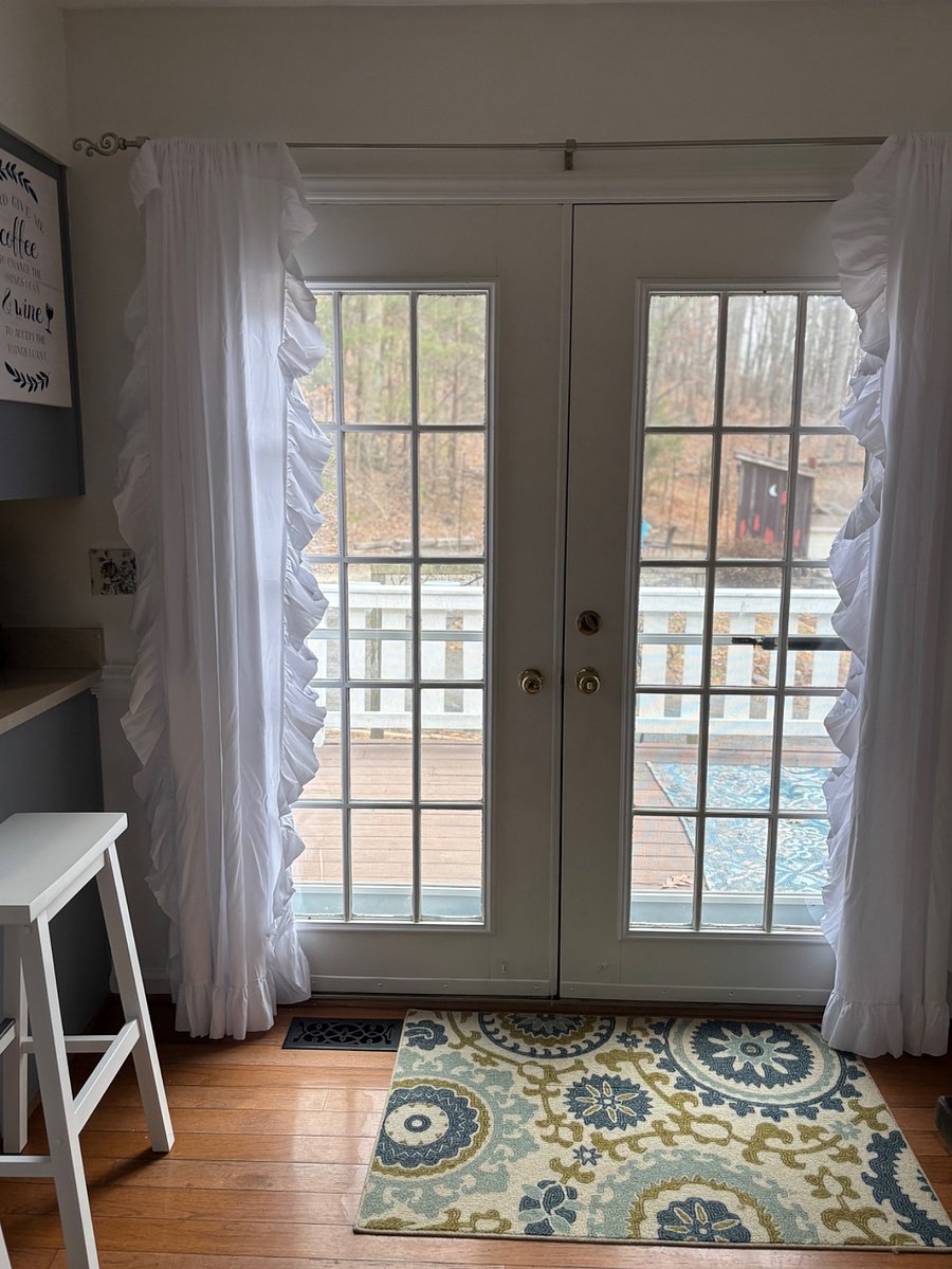 Dining room with farm house table and counter barstools. French doors lead to deck with outdoor dining and lounge seating. Interior door to the right opens to large walk-in pantry,