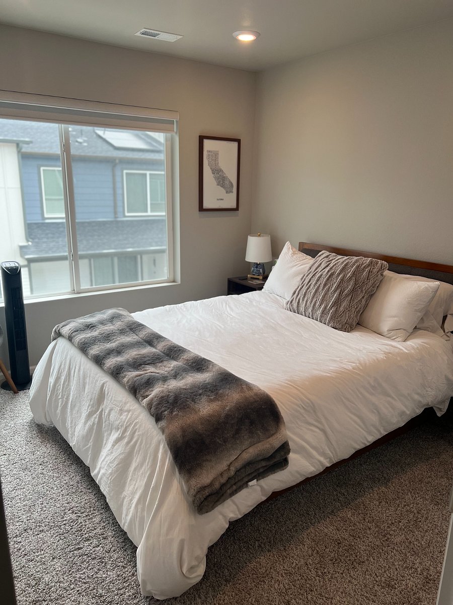 Guest bedroom with queen bed and blackout shades