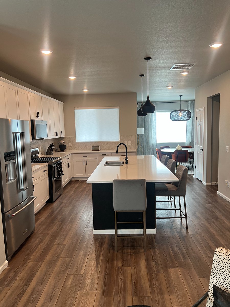 Fully stocked gourmet kitchen with dual ovens, gas stove, large french door Kitchen Aid fridge, tons of cabinets, and large pantry