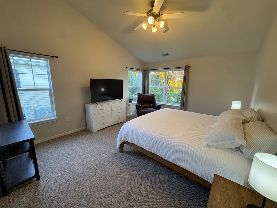 The primary bedroom features a comfy king size bed, 55" Smart TV, recliner and great views.