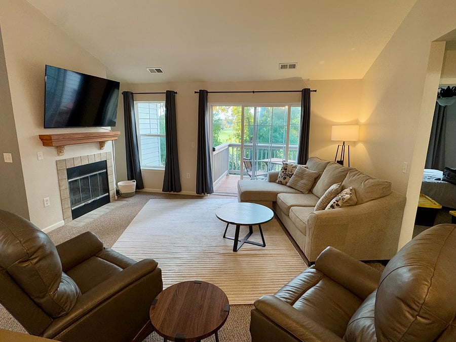 Comfy family room with great views. Vaulted ceilings, gas fireplace, 65" smart TV, sectional couch and 2 leather recliners.