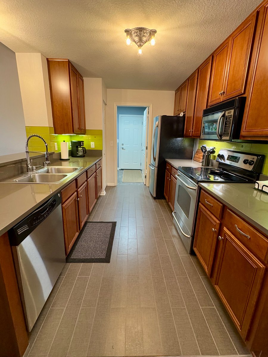 Fully stocked kitchen complete with all appliances, dishes and cookware.