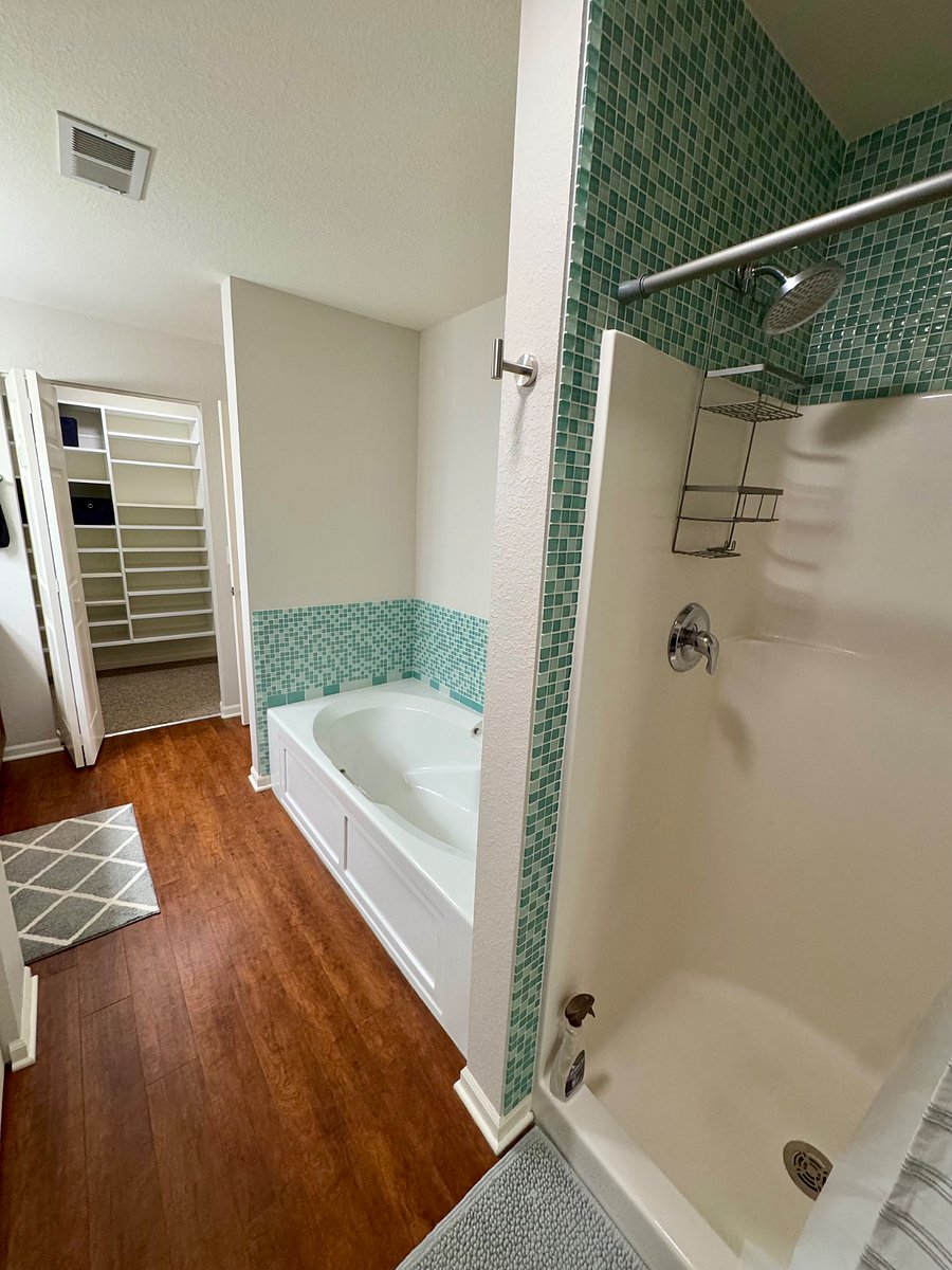 The primary bathroom features a soaking tub with separate shower.
