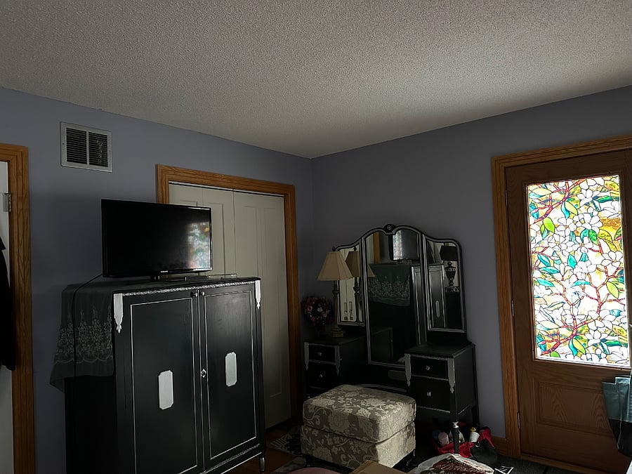 First Floor Master Bedroom- clothing Amoire and ladies dressing table with seat. Access to the rear porch.