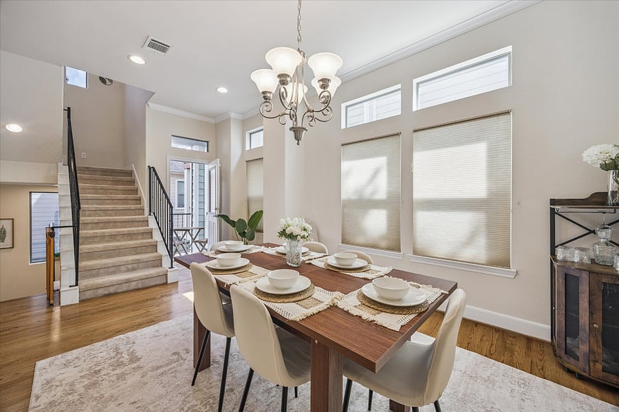 View of the small balcony off the dining room and stairs to 3rd floor bedrooms.