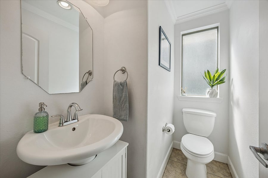 Powder bath on main floor - tucked away for privacy. Across from the laundry.