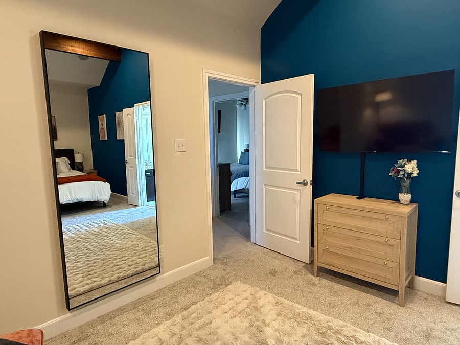 Extra large mirror in primary bedroom - perfect for a home workout.
TV can swivel to be viewed from seating area or the bed.