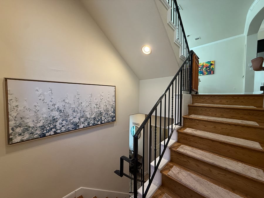 Stairway - and the neutral artwork that can be swapped for the colorful one in the dining area.