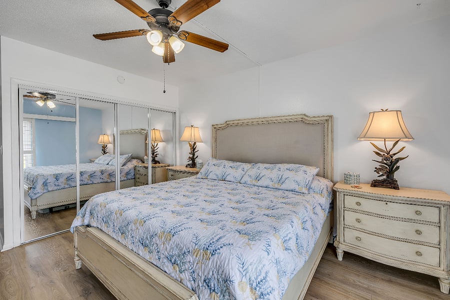 Master bedroom with beach decor and television