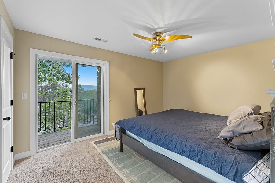 Secondary bedroom upstairs with king bed and private balcony