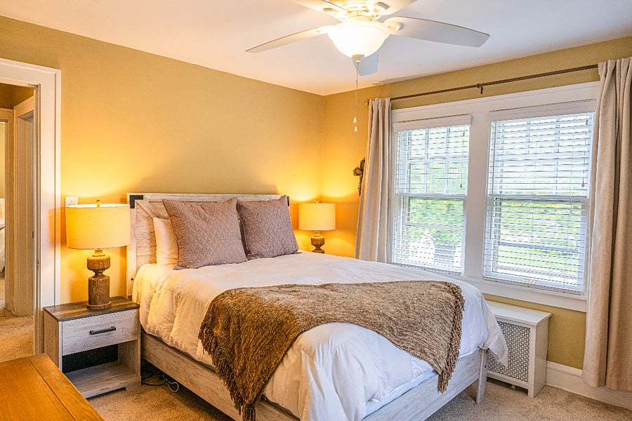 Primary bedroom with queen size bed & blackout drapes