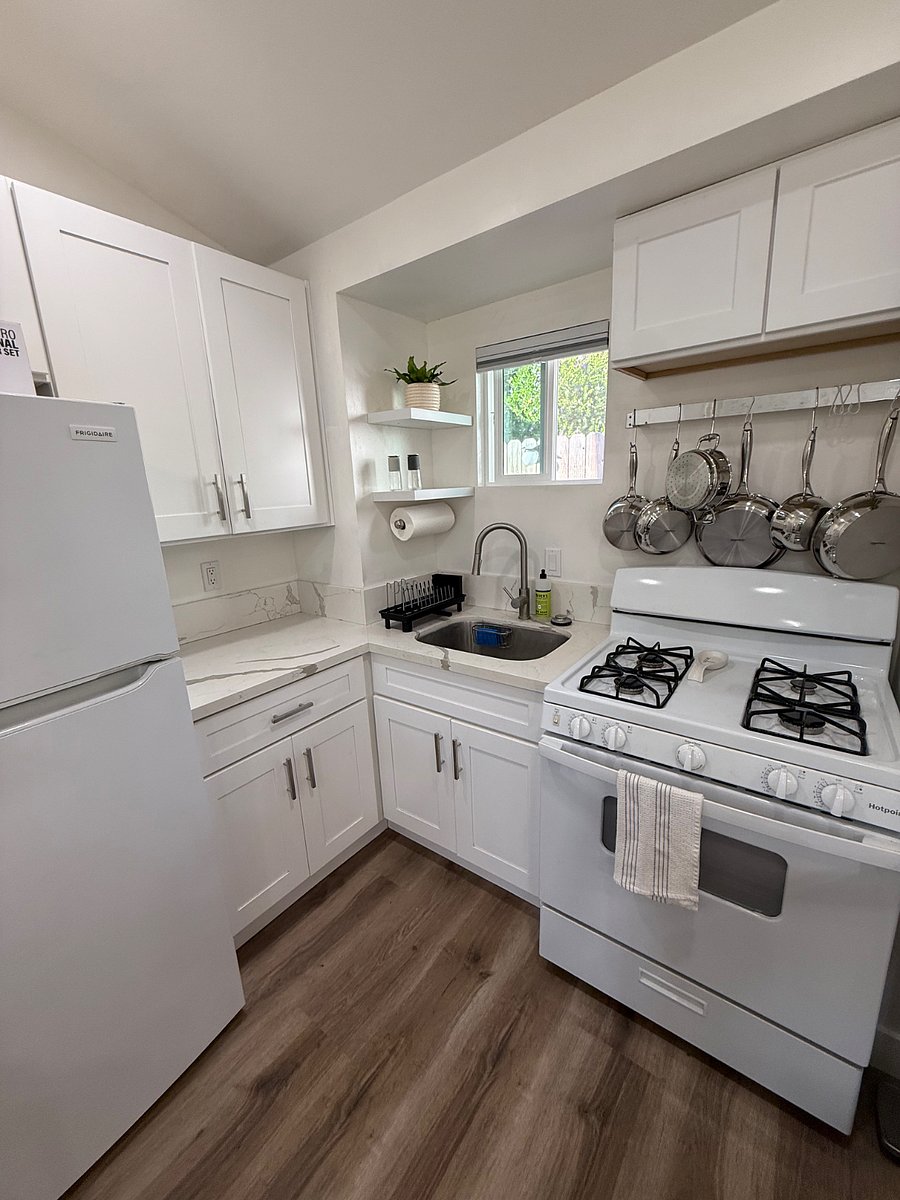 The efficient and bright kitchen has everything you need to make tasty meals at home, including Nespresso, coffee machine, microwave, convection, toaster, oven, four burner range, and all the pots pans utensils, and serviceware you need. 