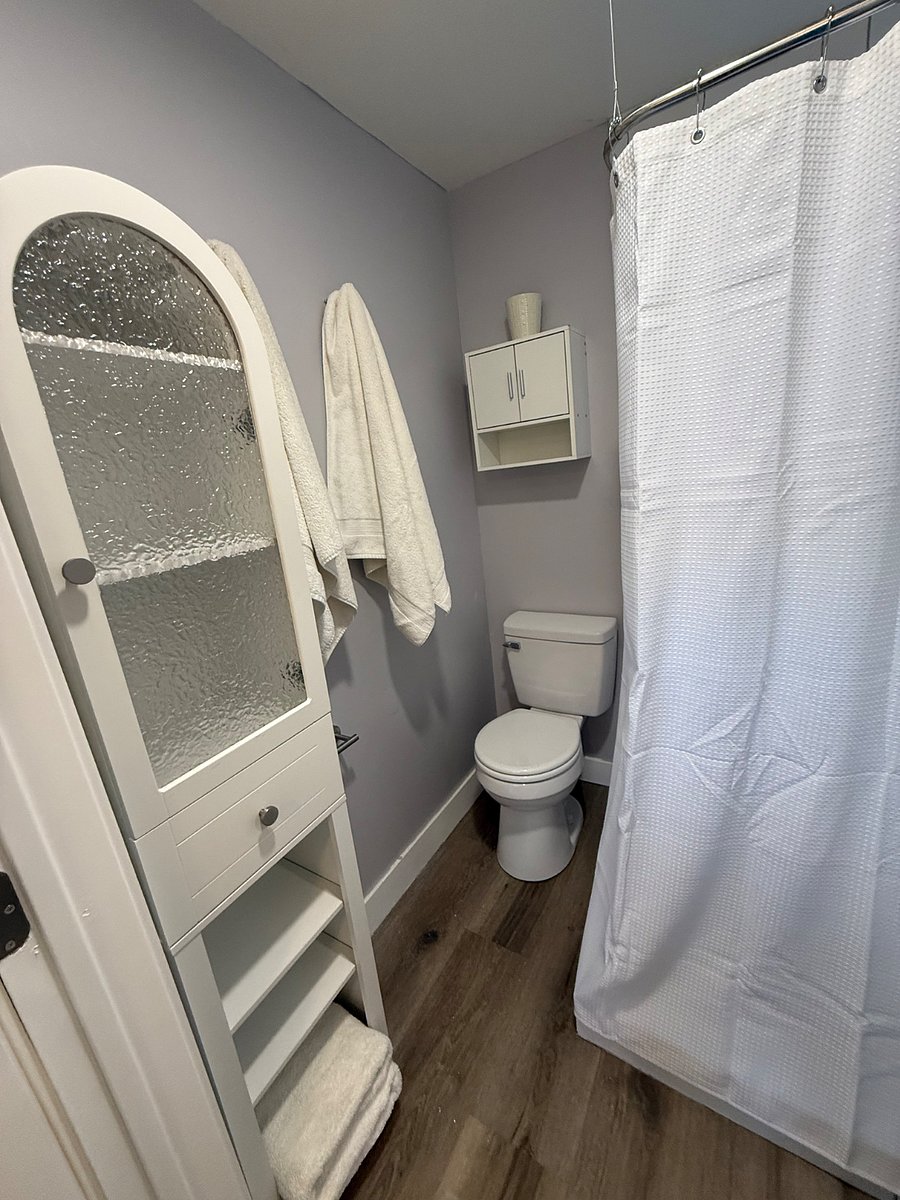Lovely bathroom with rain, head, shower, and good storage. 