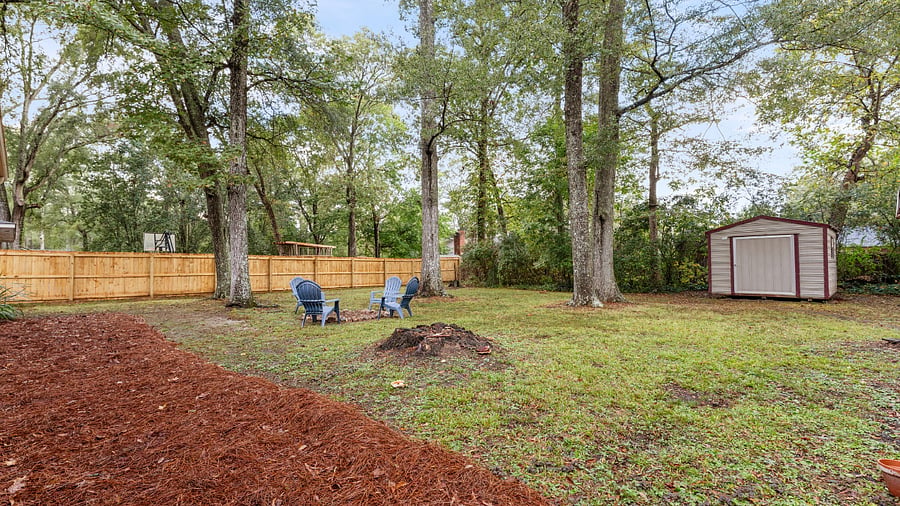 Large spacious partially-fenced backyard with gas grill, firepit and string lights. A storage shed is available for rent for an additional fee of $50/mo.