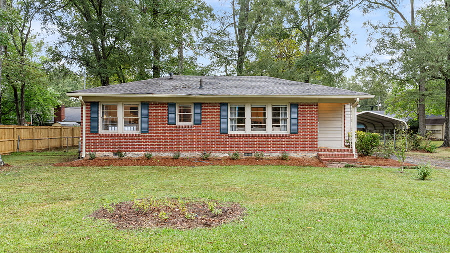 The home features a 2-car carport with additional driveway parking.