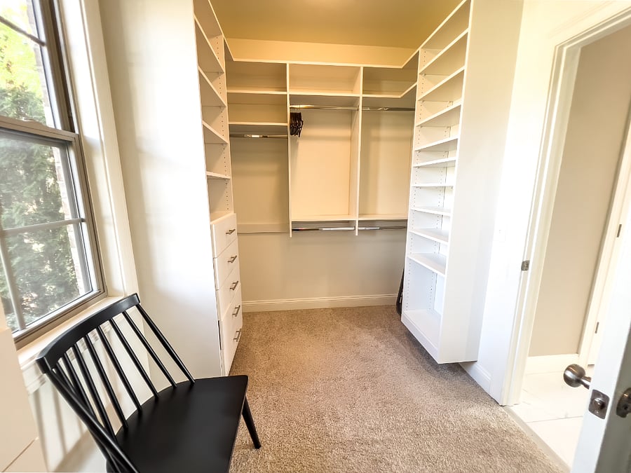Her side of the massive walk-in closet California system with so many drawers and shelves and hanging areas for clothes.