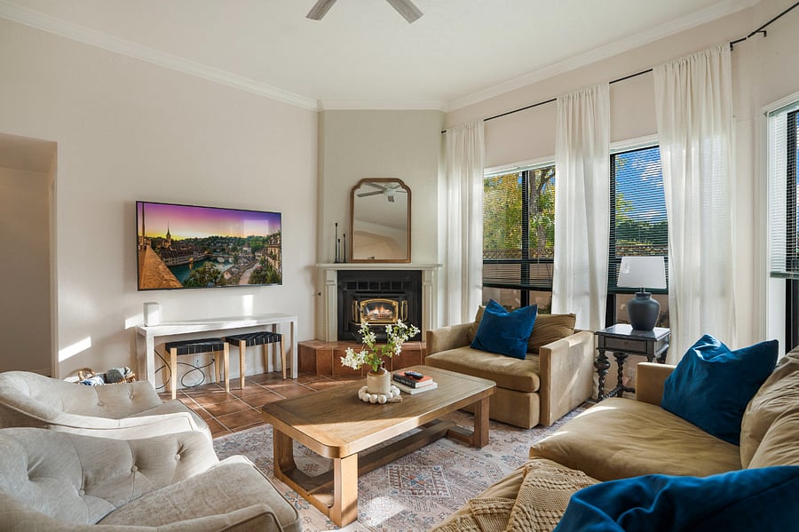 huge living room with soaring ceiling, ample seating- deep sofas and chairs, gas fireplace and natural light
