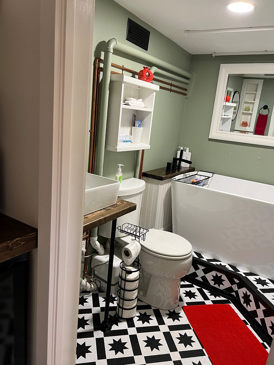Soaking tub with hand-held shower head