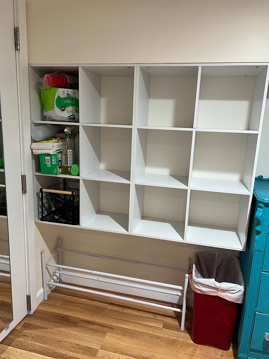 Large walk-in closet with cubicle grid, dresser, clothes rack & storage