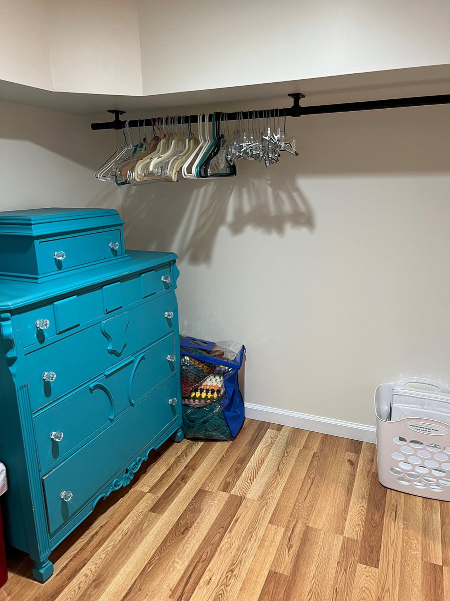 Large walk-in closet with cubicle grid, dresser, clothes rack & storage
