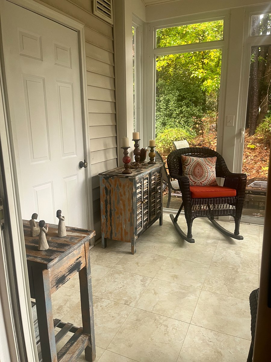 Three-season room with screens and windows, fan, sliding doors.