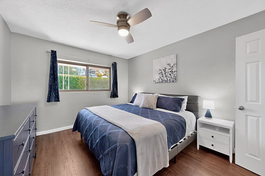 Comfortable bedroom with king bed, black-out curtains, dresser, large walk-in closet