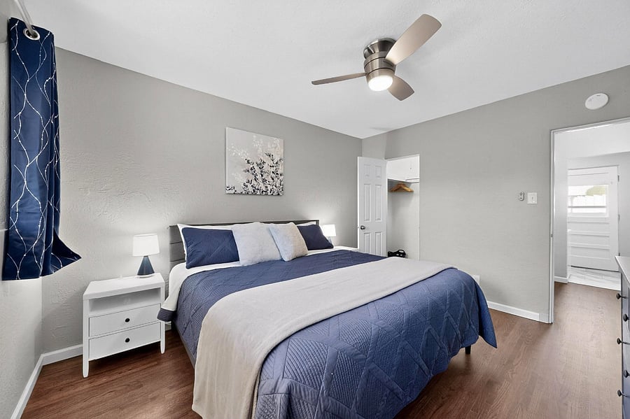 Comfortable bedroom with king bed, black-out curtains, dresser, large walk-in closet