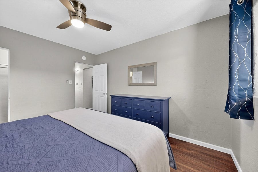Comfortable bedroom with king bed, black-out curtains, dresser, large walk-in closet
