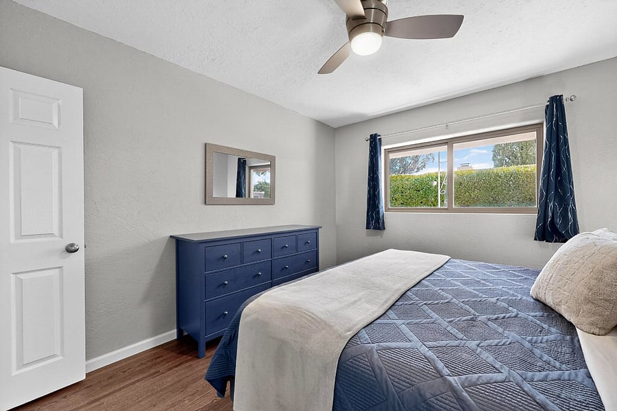 Comfortable bedroom with king bed, black-out curtains, dresser, large walk-in closet