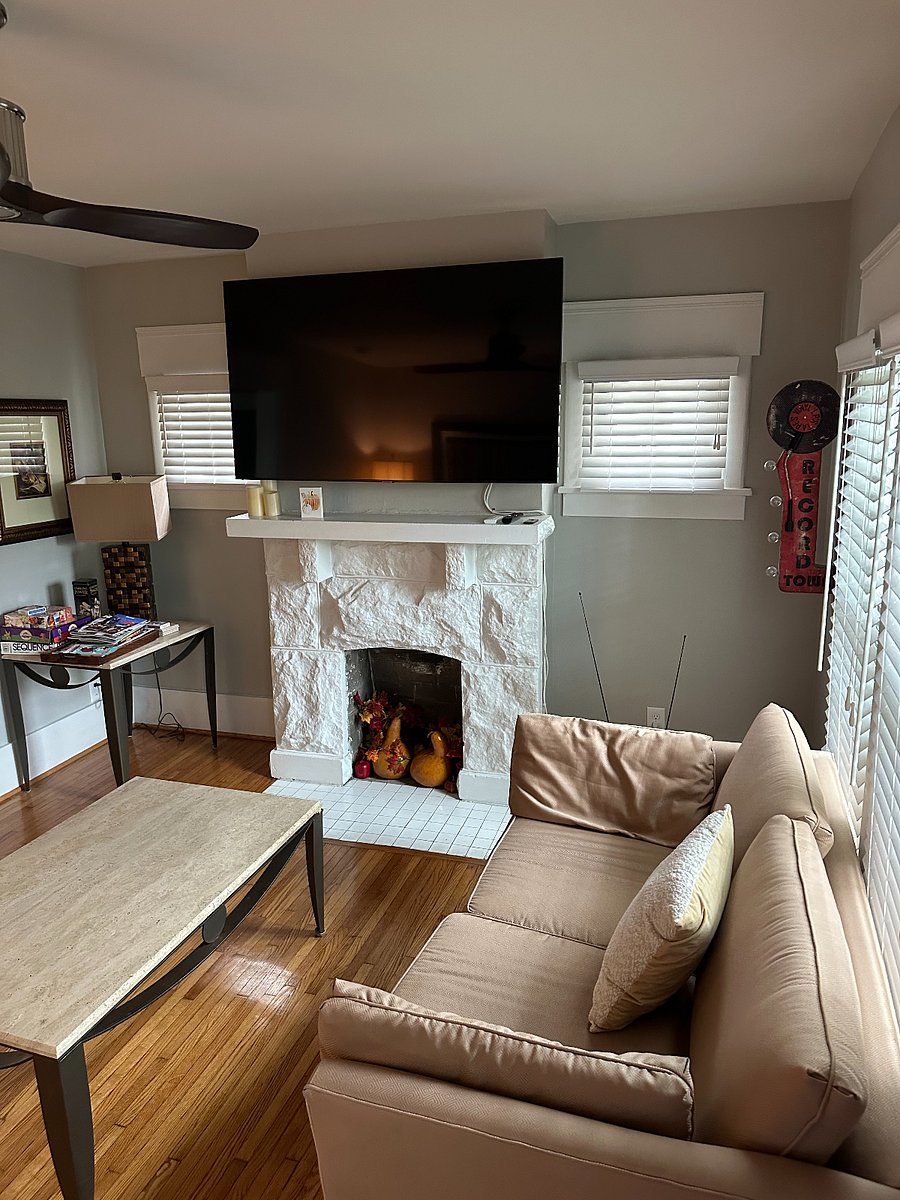 In the living area, looking toward the ornamental fireplace with Tv above