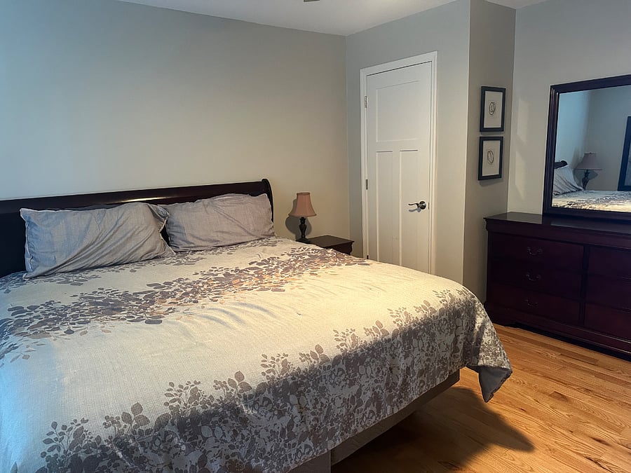 Another view of the king bedroom upstairs with the full bath with a shower