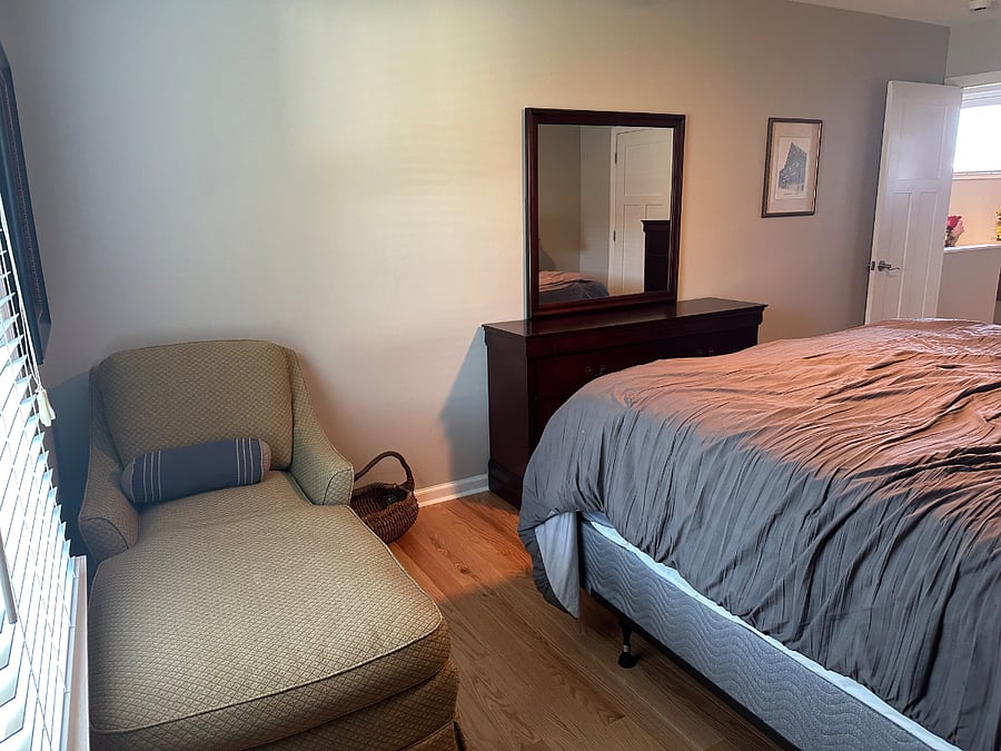 Lounger that is in a king bedroom upstairs