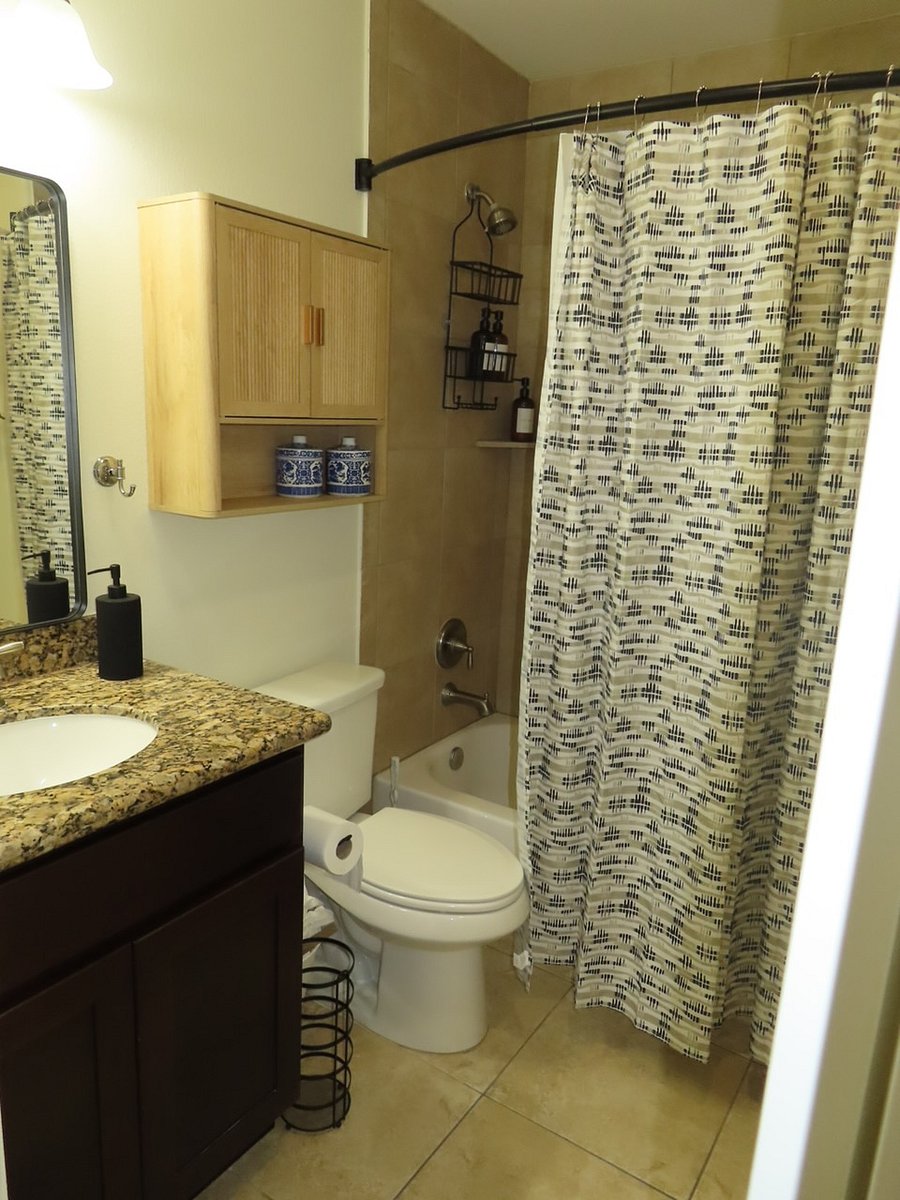 Bathroom with Tub/Shower combo, granite countertop and additional storage