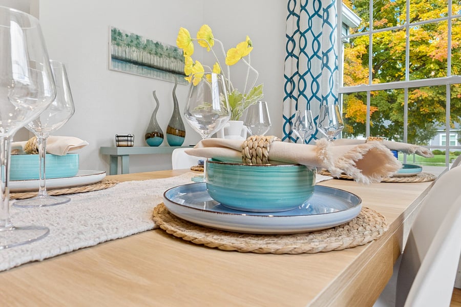 Set to impressour South Bend guest retreat dining room offers beautiful, colorful dishes for a fancy dinner, plus plastic options for kids or alfresco meals. Style meets practicality near Notre Dame.