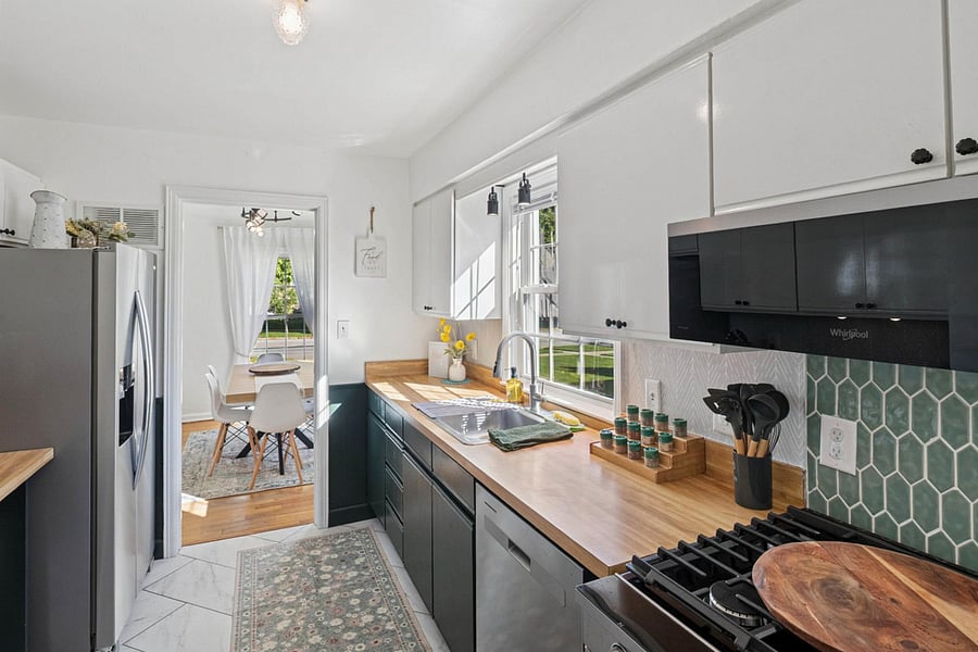 Ready to cook, bake, and gather our South Bend kitchen features a sleek dishwasher, stainless range, stocked spices, utensils, and a pizza peel for alfresco meals near Notre Dame.
