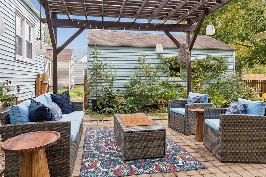Lounge in shaded comfort beneath the pergolaour cushioned backyard sofa sits steps from the herb garden and pizza oven. A cozy South Bend retreat near Notre Dame, perfect for alfresco fun.