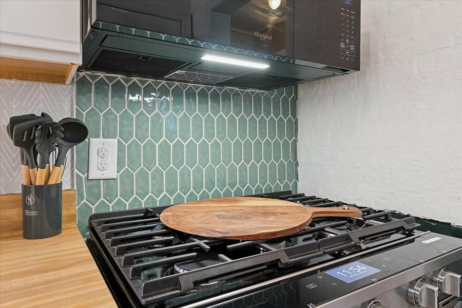 Sleek meets savoryour South Bend kitchen features new stainless steel Whirlpool appliances and a wooden pizza peel, perfect for prepping alfresco pies and family-style meals with ease.