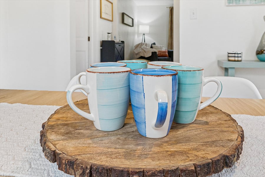 Classy cups circle the lazy Susan in our South Bend dining room, flanked by coasters and a peek at your favorite reading nookperfect for sipping, gathering, and unwinding near Notre Dame.