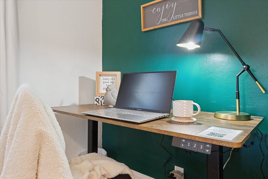 Power up your productivity in our South Bend guest retreatfeaturing an electric standing desk with built-in outlets, charging ports, and a comfy chair. Perfect for remote work near Notre Dame