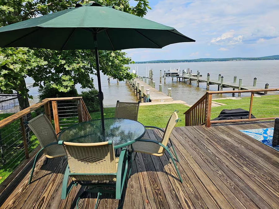 Dining area on deck facing Bay with umbrella
