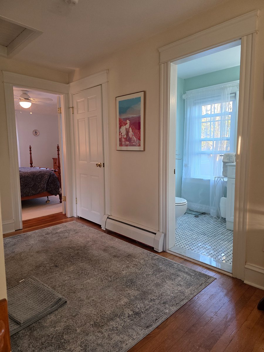 View of second floor bathroom and one of 3 rooms from stairs landing