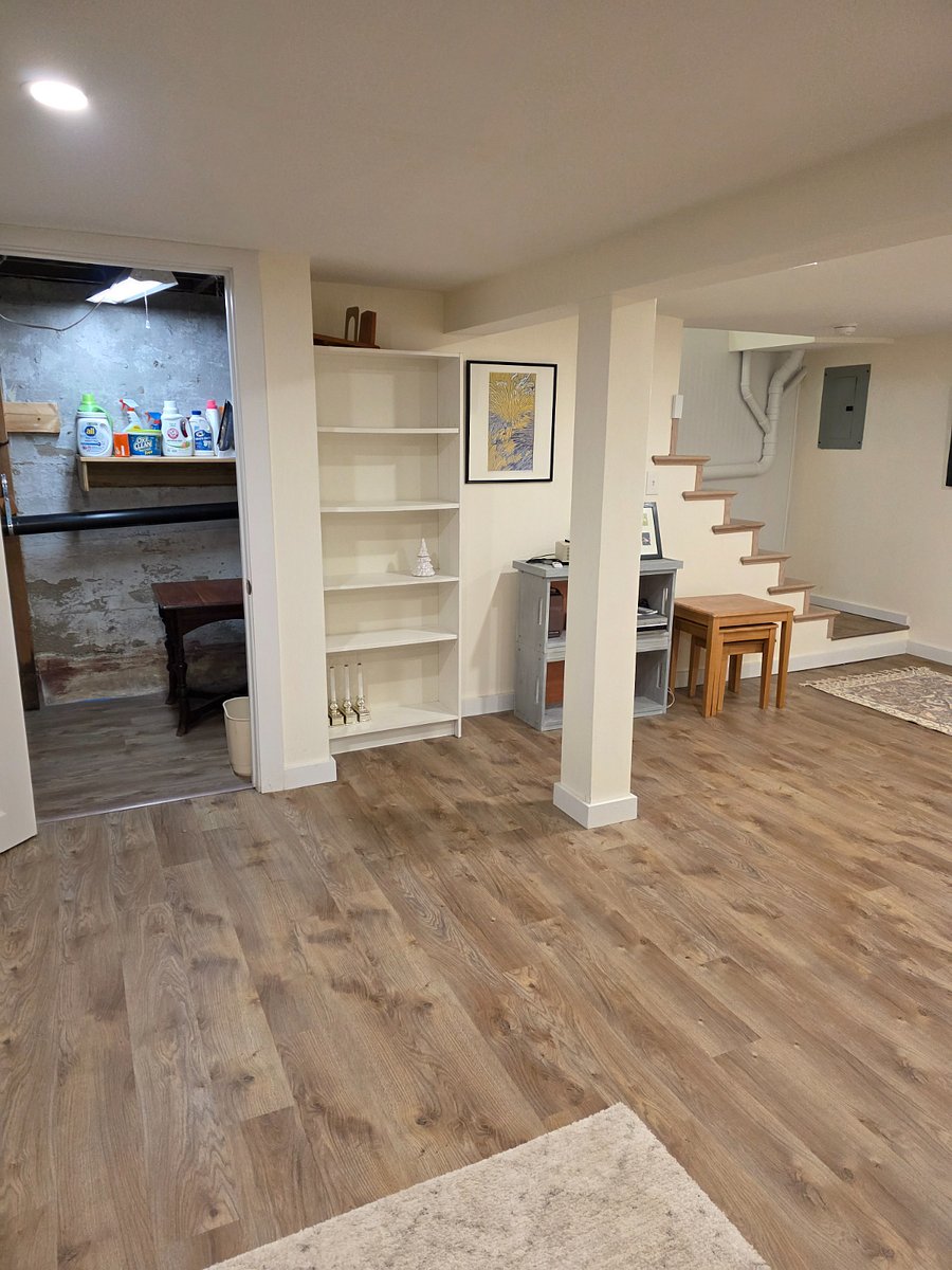 Basement view of stairs and laundry room