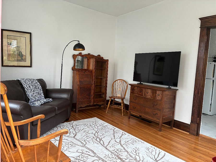 Living space as you enter the front door. Leather loveseat, Smart TV, drop-down desk surface in bookcase, Choose the lighting option that suits your mood.